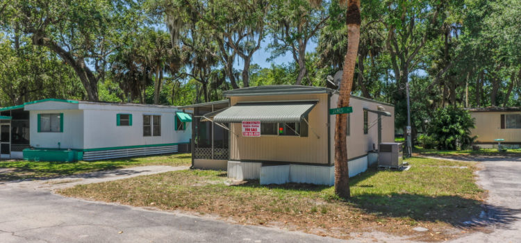 Home is located under towering oaks